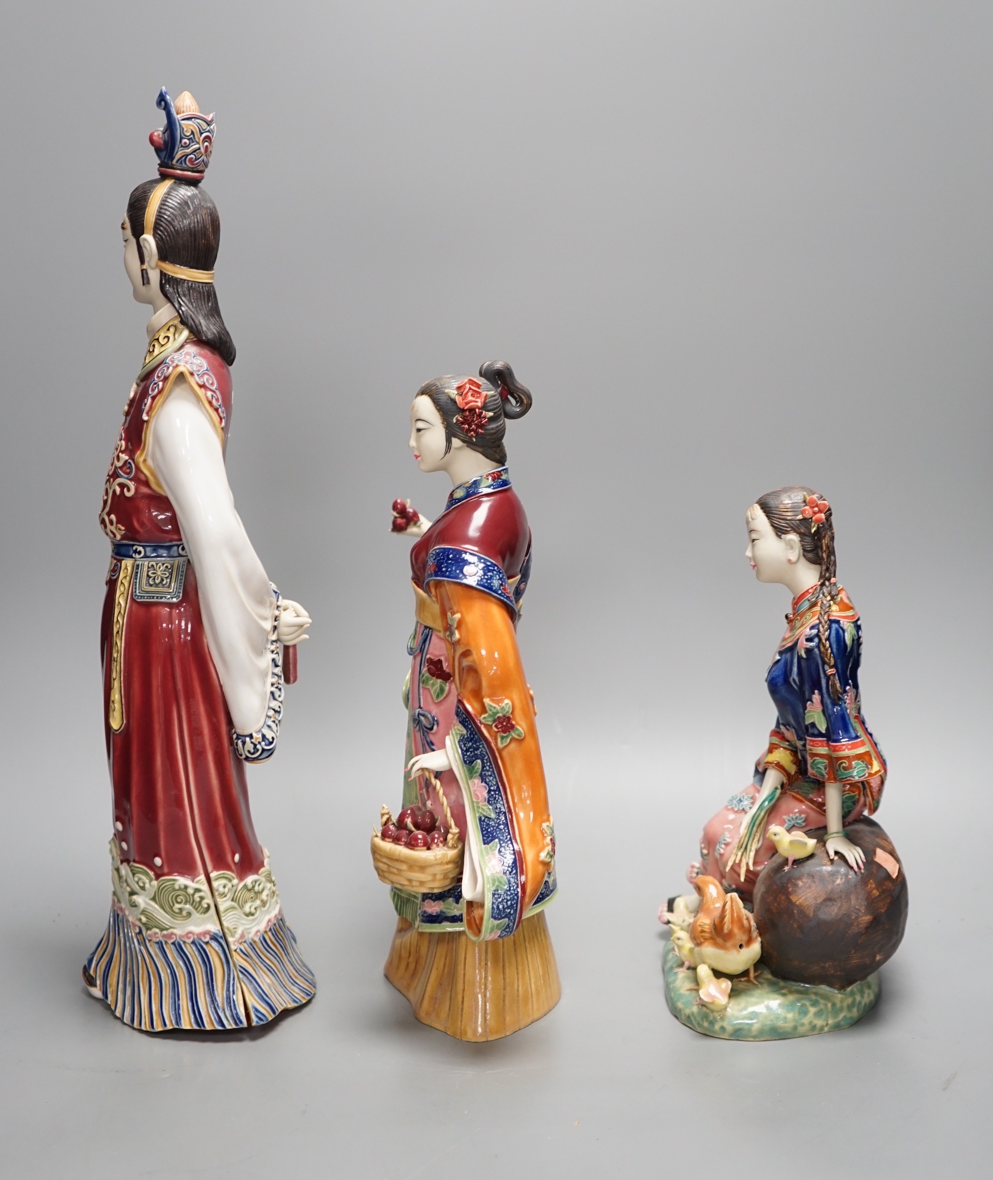 Three Chinese pottery figures, one signed, tallest 42cm